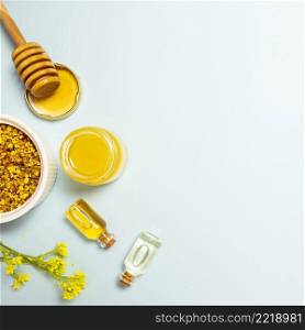 essential oil bee pollen honey with yellow fresh flower blue backdrop
