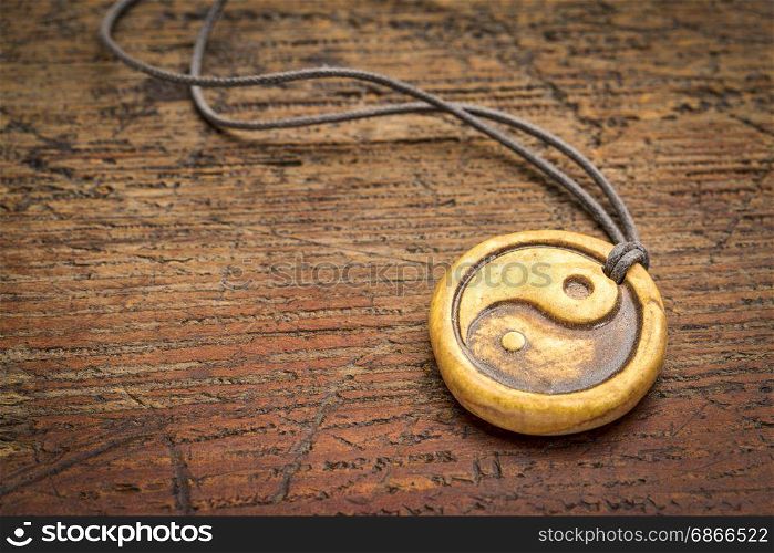 essential oil diffuser ceramic pendant with yin and yang symbol on grunge weathered wood