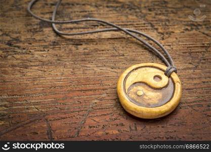 essential oil diffuser ceramic pendant with yin and yang symbol on grunge weathered wood