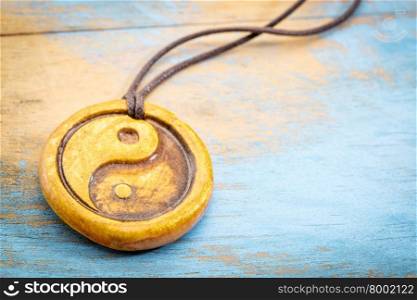 essential oil diffuser ceramic pendant with yin and yang symbol on grunge wood