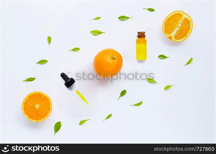Essential oil from oranges on white background.