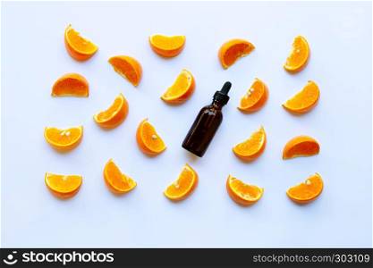 Essential oil with citrus fruits on white background.
