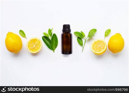 Essential oil with fresh lemon with leaves isolated on white background. Top view