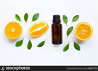 Essential oil with fresh orange citrus fruit and leaves isolated on white background.