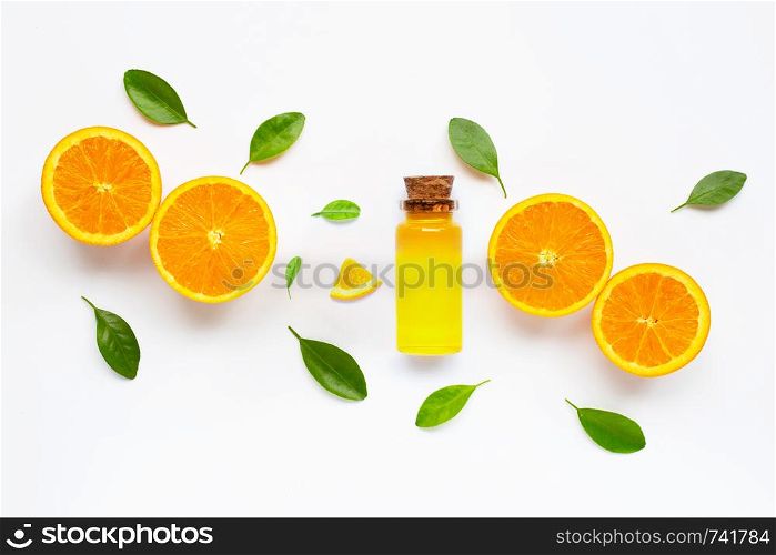 Essential oil with fresh orange citrus fruit with leaves isolated on white background.