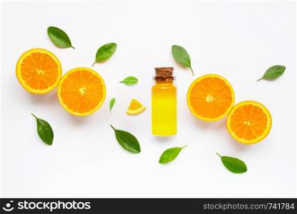 Essential oil with fresh orange citrus fruit with leaves isolated on white background.