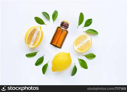Essential oil with lemon and slices isolated on white background.