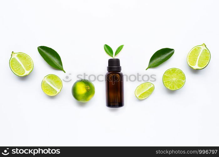 Essential oil with Limes and leaves isolated on white background.