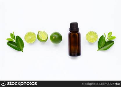 Essential oil with Limes and leaves isolated on white background.