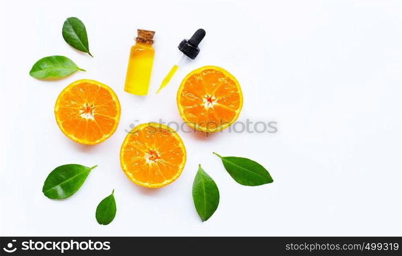Essential oil with oranges on white background.