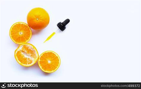 Essential oil with oranges on white background. Copy space
