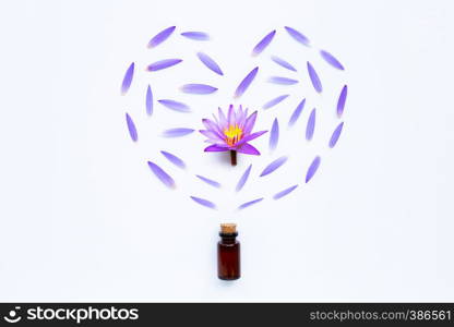 Essential oil with Purple lotus flower on white background.