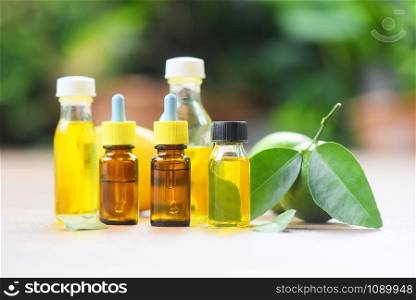 Essential oils / Aromatherapy herbal oil bottles aroma with formulations lime lemon herbal and nature green background