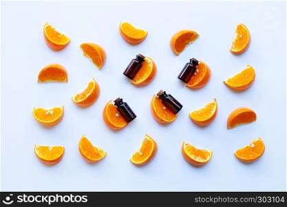 Essential oils with citrus fruits on white background.