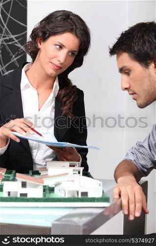 Estate agent and client discussing contracts