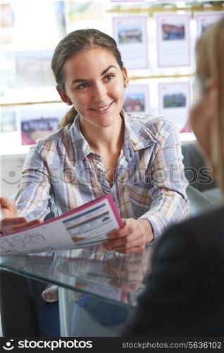 Estate Agent Discussing Property With Client In Office