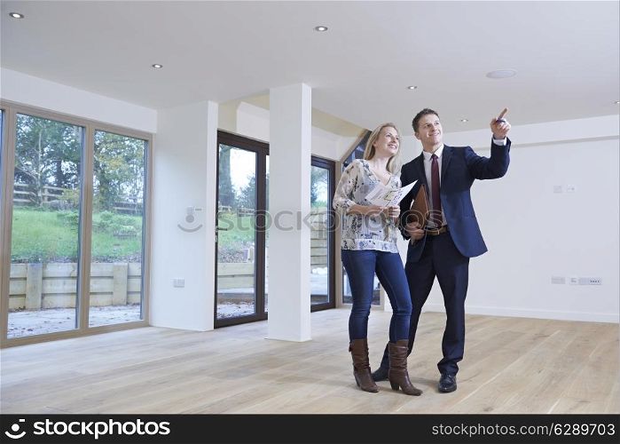 Estate Agent Showing Prospective Female Buyer Around Property