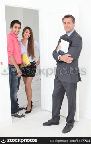 Estate agent with young couple