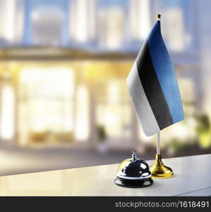 Estonia flag on the reception desk in the lobby of the hotel.. Estonia flag on the reception desk in the lobby of the hotel