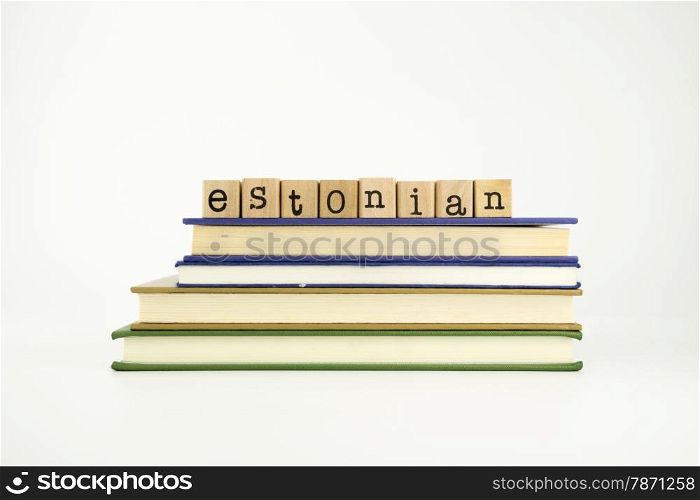estonian word on wood stamps stack on books, language and conversation concept