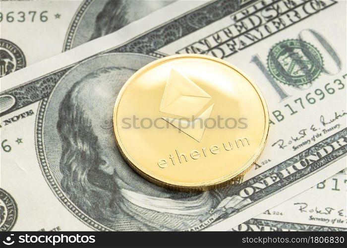 Ethereum coin on dollar banknotes. Cryptocurrency on US dollar bills