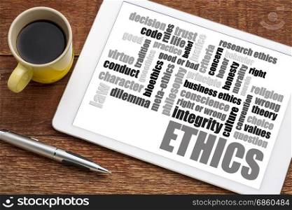 ethics and moral dilemma word cloud on a digital tablet with a cup of coffee