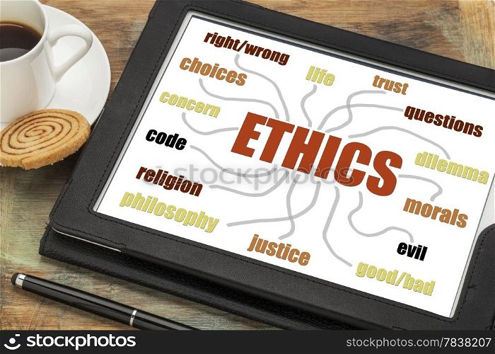 ethics word cloud or mind map on a digital tablet with a cup of coffee