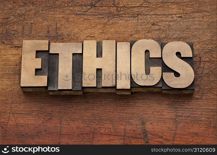 ethics word in vintage letterpress printing blocks against grunge wood background
