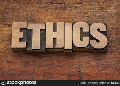 ethics word in vintage letterpress printing blocks against grunge wood background