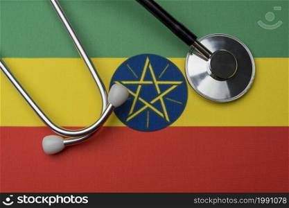 Ethiopia flag and stethoscope. The concept of medicine. Stethoscope on the flag as a background.. Ethiopia flag and stethoscope. The concept of medicine.
