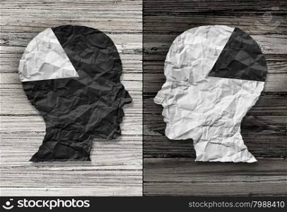 Ethnic equality concept and racial justice symbol as a black and white crumpled paper shaped as a human head on old rustic wood background with contrasting tones as a metaphor for social race issues.