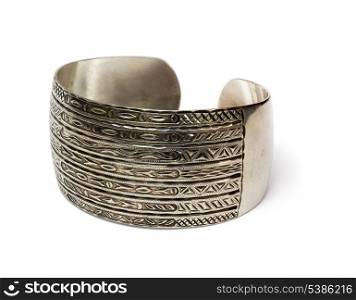 Ethnic silver bangle with handmade ornament isolated on white