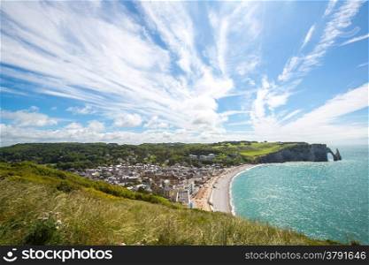 Etretat village, its bay beach and Aval cliff landmark. Aerial view. Normandy, France