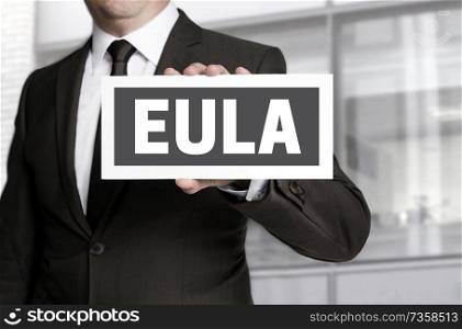 EULA sign is held by businessman background.. EULA sign is held by businessman background