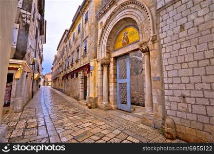 Euphrasian Basilica gate and Porec stone street view, UNESCO world heritage site in Istria, Croatia