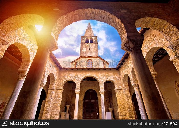 Euphrasian Basilica in Porec arcades and tower sun haze view, UNESCO world heritage site in Istria, Croatia