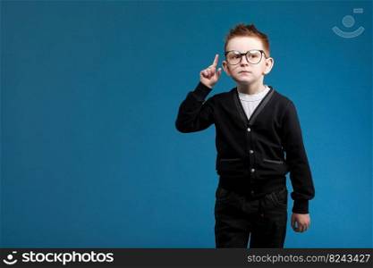 eureka, handsome little boy in glasses is surprised, inspired, I have an idea, Raise your index finger up, copy space, isolated on blue background.. eureka, handsome little boy in glasses is surprised, inspired, I have an idea, Raise your index finger up, copy space, isolated on blue background