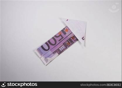 euro arrow origami. Arrow origami made of euro bills on a white background