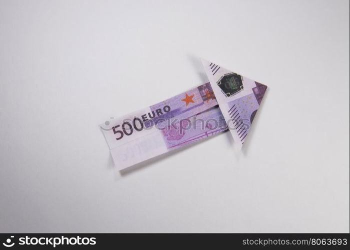 euro arrow origami. Arrow origami made of euro bills on a white background