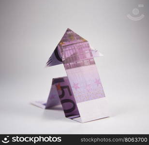 euro arrow origami. Arrow origami made of euro bills on a white background