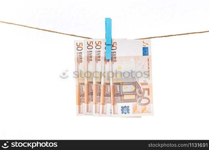 Euro banknotes are attached with blue clothespins to a rope on a white background