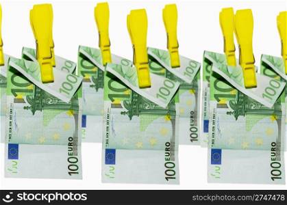 euro banknotes hanging on clothespins on white background