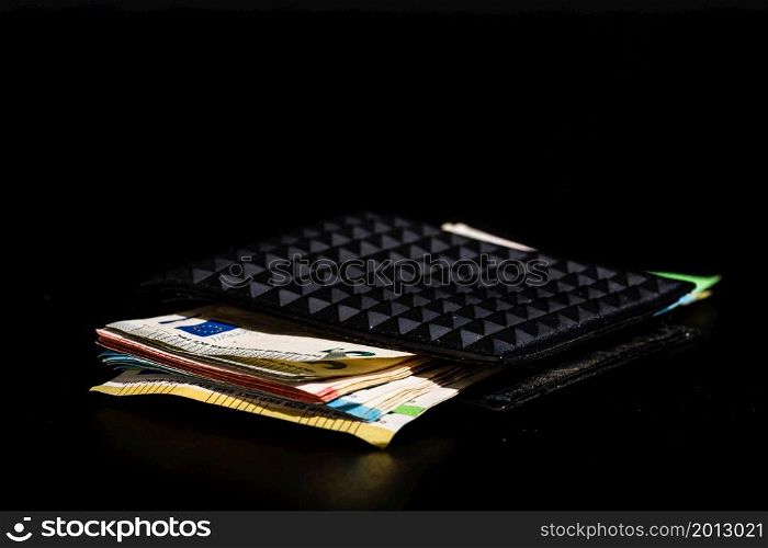 Euro banknotes in black wallet isolated.