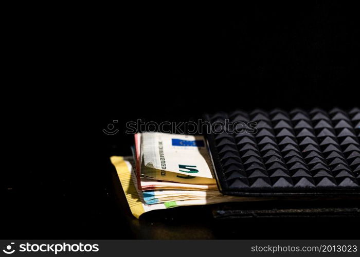 Euro banknotes in black wallet isolated.