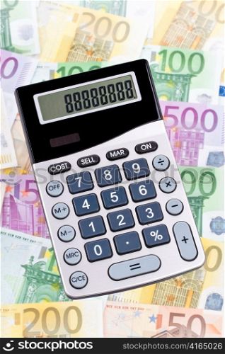 euro banknotes money and a calculator. calculation of revenue and profit