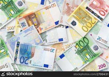 Euro banknotes of 200, 100, 50, 20, 10 and 5 Euroes spread randomly on a table.