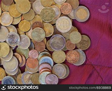 Euro coins, European Union over red velvet background. Euro coins money (EUR), currency of European Union over crimson red velvet background