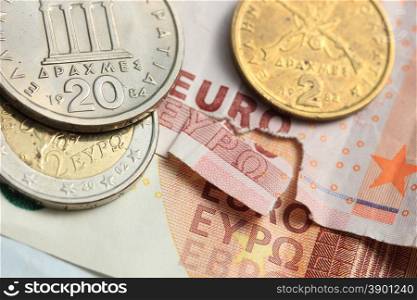 Euro crisis, a vintage Greek Drachma coin and a torn euro note