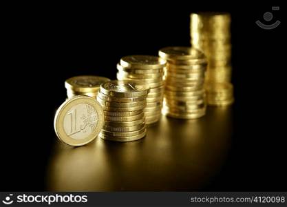 Euro currency coin columns with golden reflections