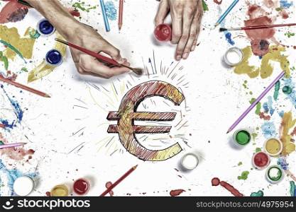 Euro currency concept. Top view of hands drawing euro currency concept